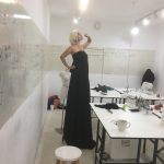 Testing the fit of strapless silk with Halston construction at Tchad workrooms