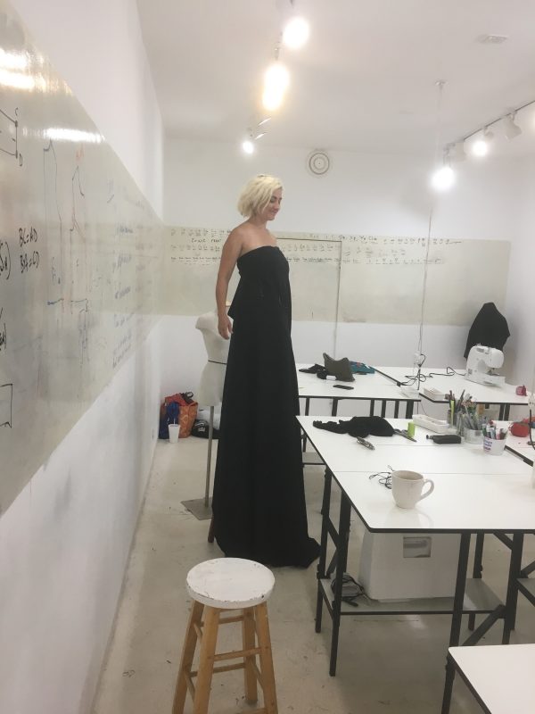Testing the fit of strapless silk with Halston construction at Tchad workrooms