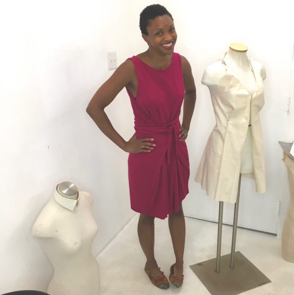 Omoleye models her version of the Kielo Wrap dress in fuchsia knit by Named Patterns at the Tchad workroom sewing studio in Chicago