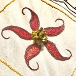 Five-point embroidered flower with beaded center in red and gold by Nathan Perez for the tambour class he will be teaching at Tchad workroom sewing studio in Chicago in August