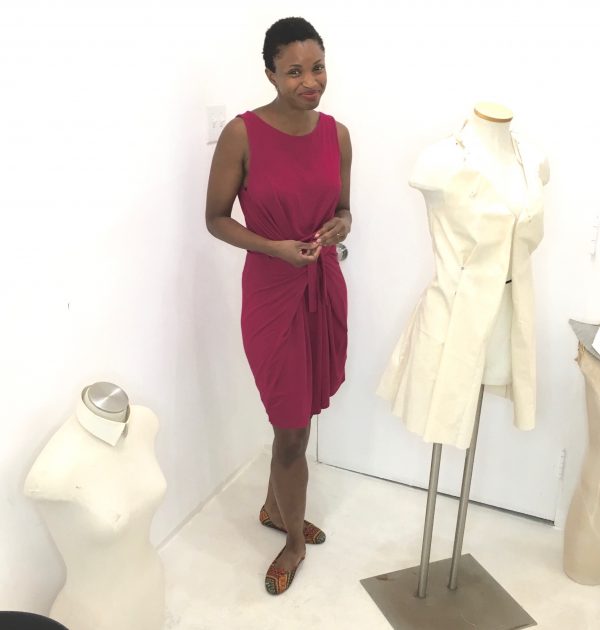 Omoleye models her version of the Kielo Wrap dress in fuchsia knit by Named Patterns at the Tchad workroom sewing studio in Chicago