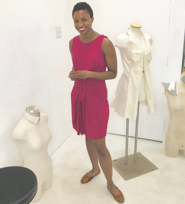 Omoleye models her version of the Kielo Wrap dress in fuchsia knit by Named Patterns at the Tchad workroom sewing studio in Chicago