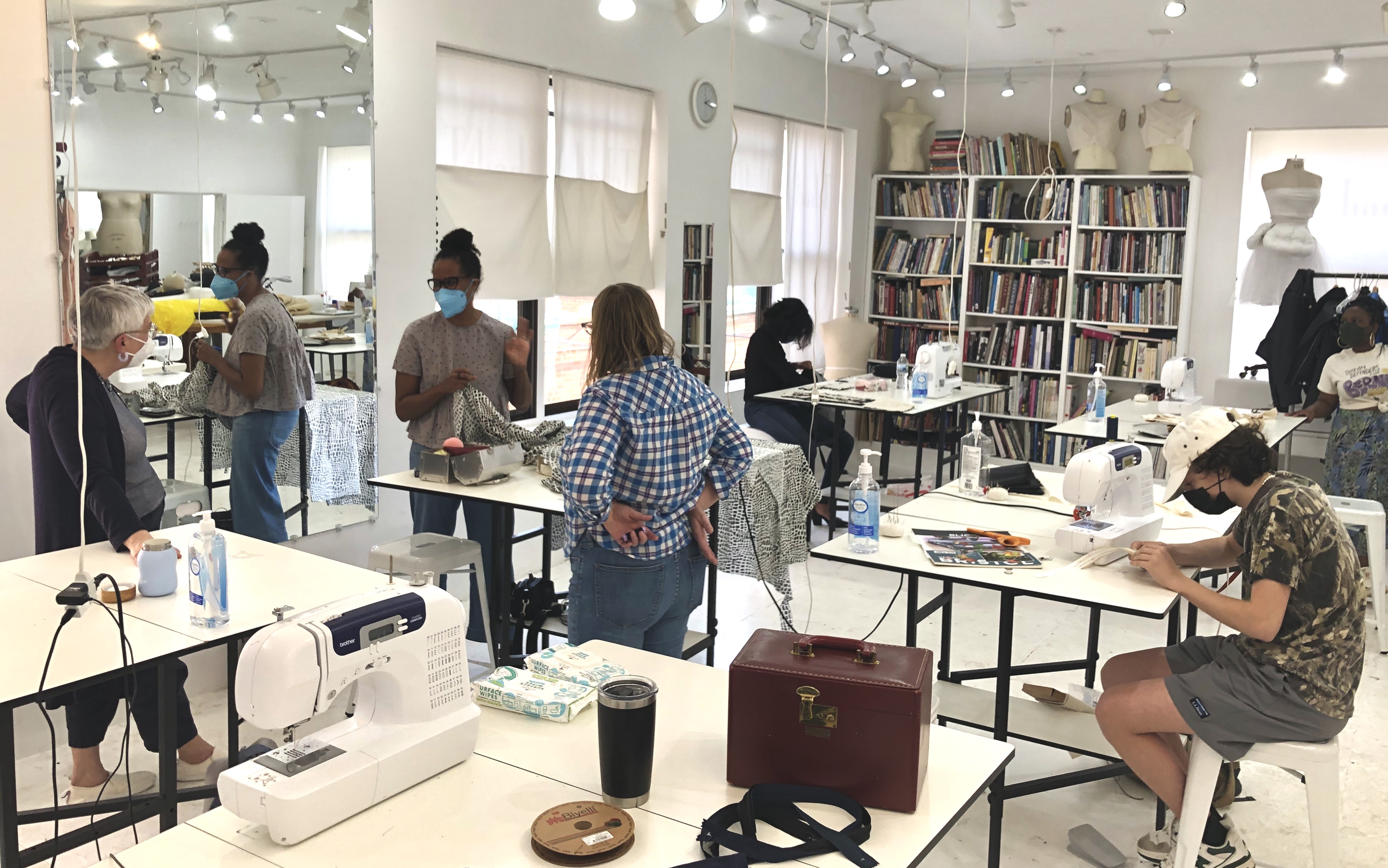 Students in Tchad Workroom sewing studio talking and sewing in chicago
